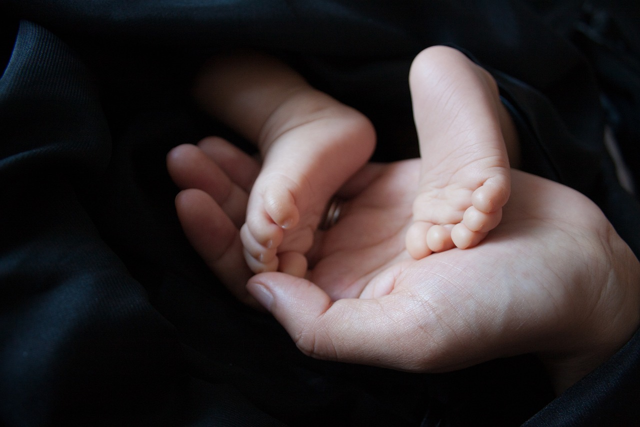 baby feet in hands